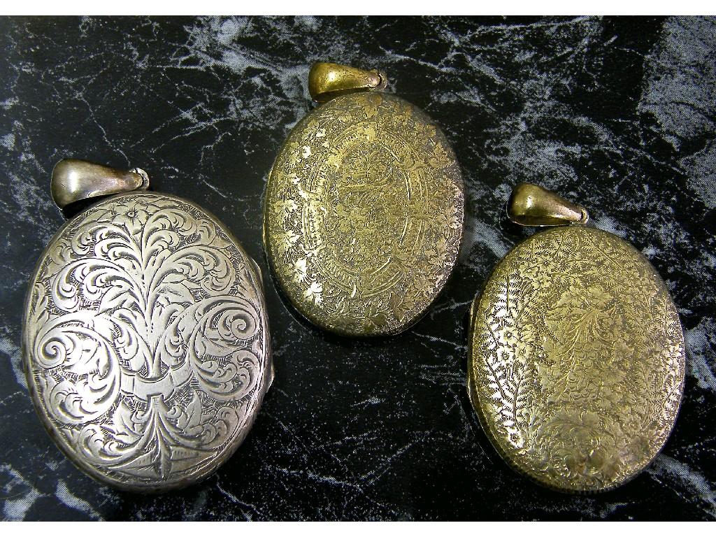 Appraisal: Four engraved locket pendants jet locket pendant pair of oval