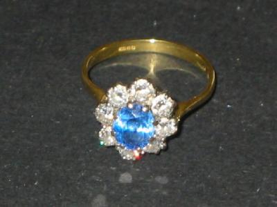 Appraisal: A SAPPHIRE AND DIAMOND CLUSTER RING the pale blue oval