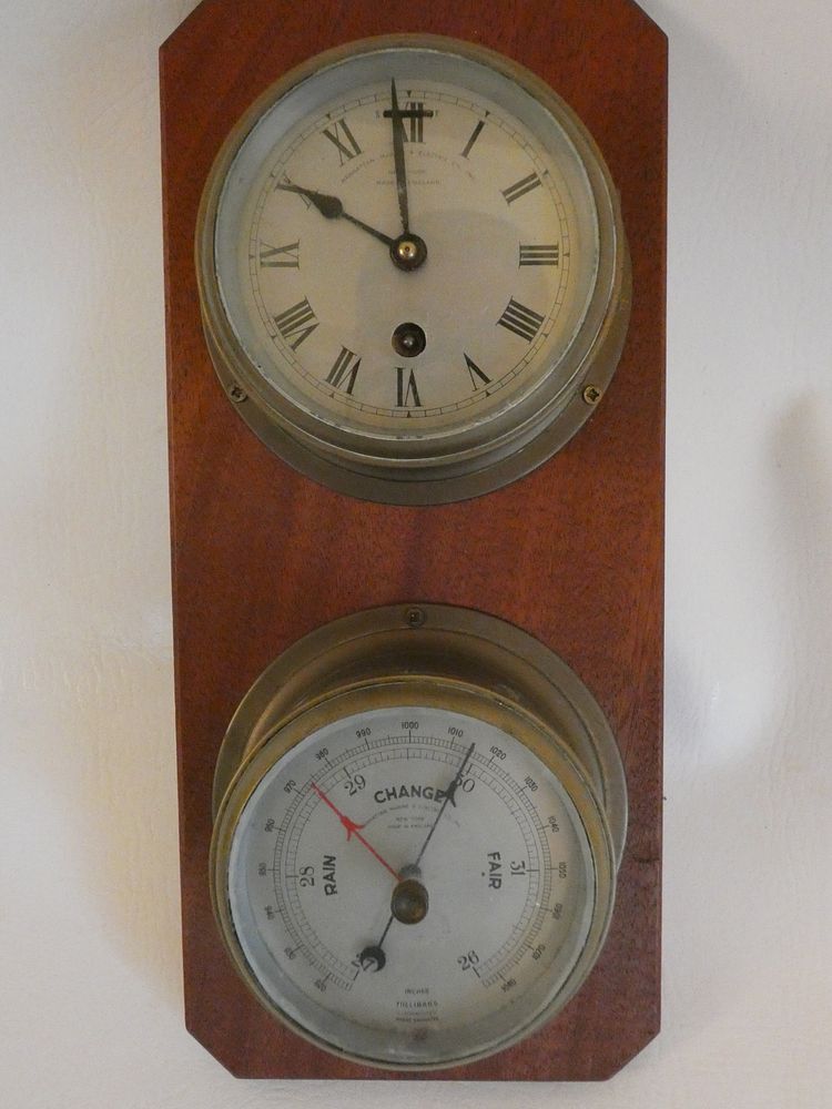 Appraisal: MARINE BAROMETER CLOCK SET English vintage brass clock and barometer