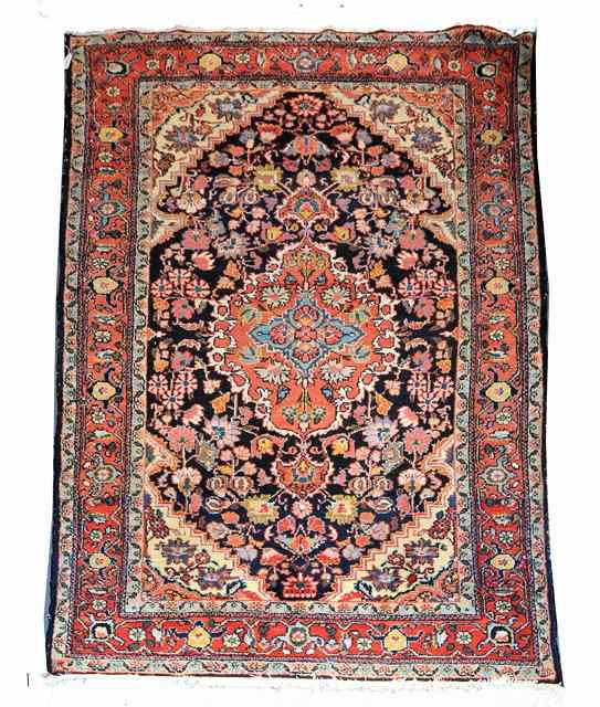 Appraisal: A PERSIAN BLUE GROUND RUG decorated a central brick ground