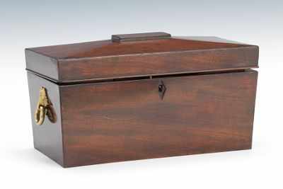 Appraisal: A Mahogany Veneered Tea Caddy Sarcophagus form mahogany veneered hinged