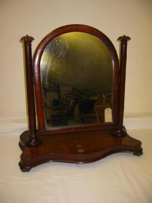 Appraisal: A VICTORIAN MAHOGANY TOILET MIRROR the arched plate on turned