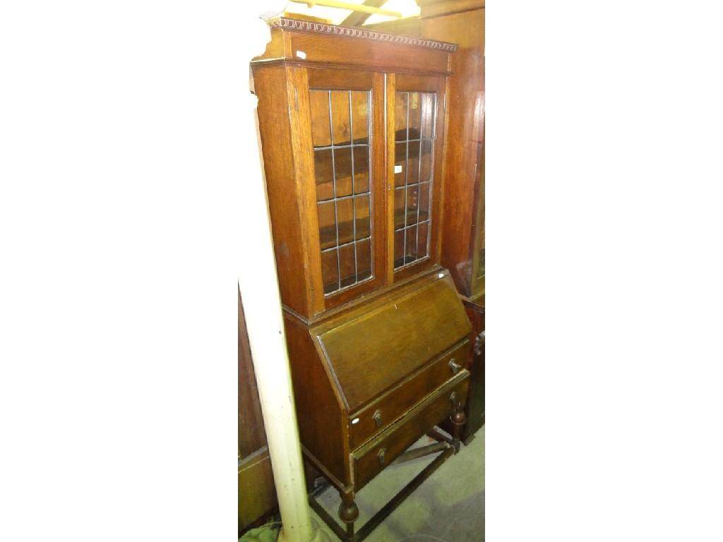 Appraisal: A 's oak bureau bookcase the upper section enclosed by