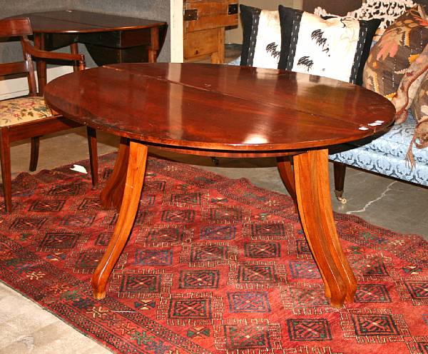 Appraisal: An Italian Neoclassical style mahogany extension dining table with two