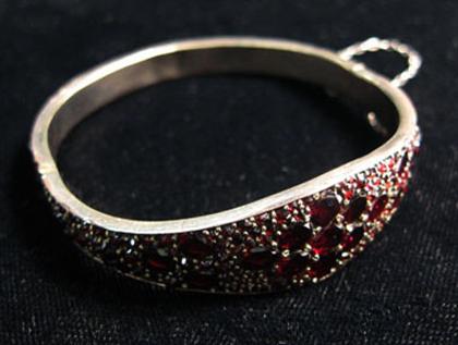 Appraisal: Victorian silver and garnet bangle Round and rose cut diamonds