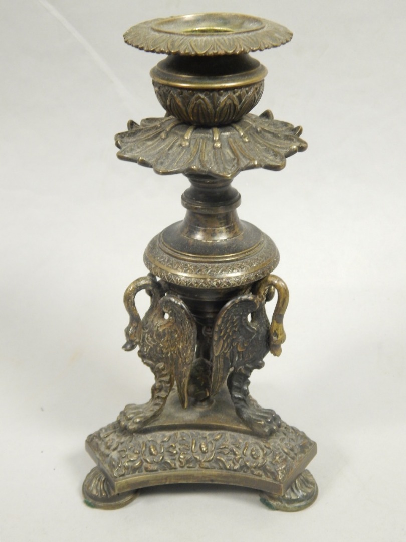 Appraisal: A mid thC bronze candlestick cast with swan type supports