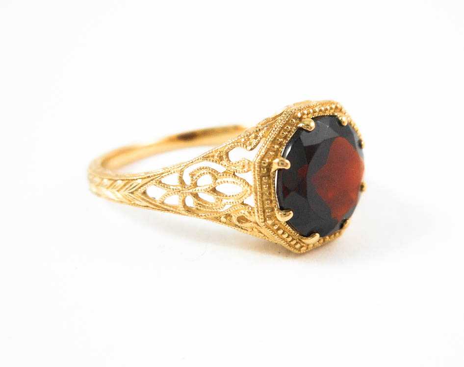 Appraisal: GARNET AND FOURTEEN KARAT GOLD RING The yellow gold filigree