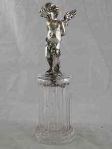 Appraisal: A rock crystal column with a silver figure of Cupid