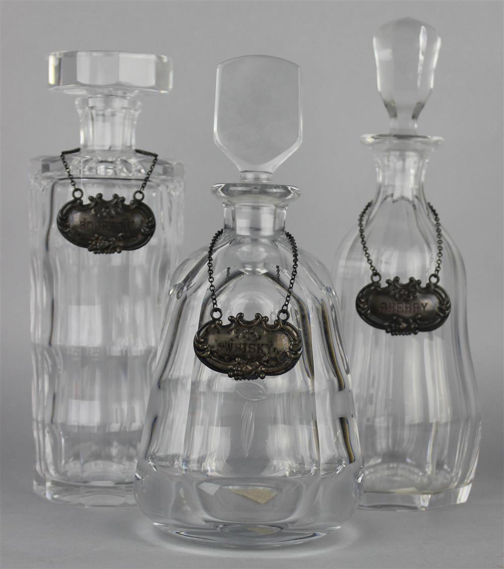 Appraisal: THREE GLASS DECANTERS KOSTA BODA AND ORREFORS an assembled group