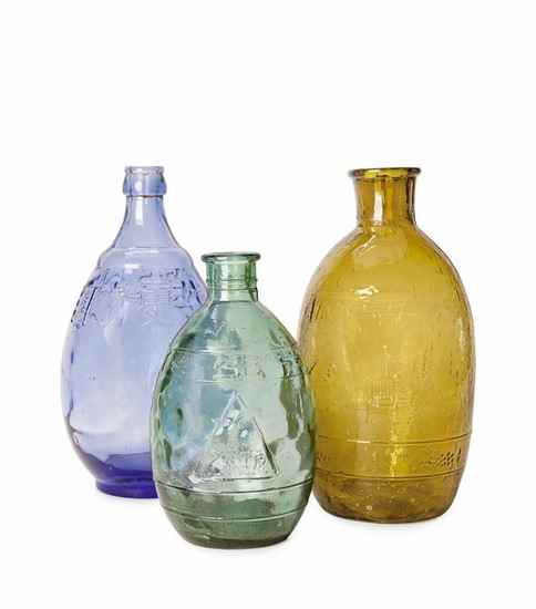 Appraisal: Three Propaganda Glass Jars group of decorative bottles with tractor