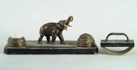 Appraisal: TWO PIECE METAL FIGURAL DESK SET Double inkwell pen stand