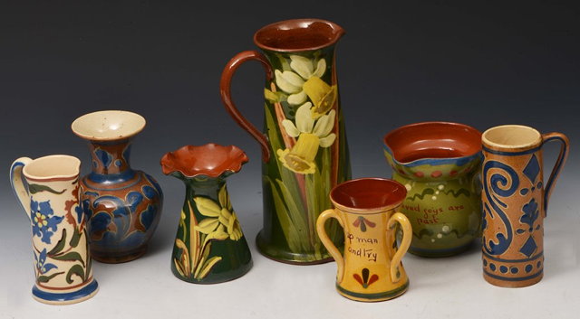 Appraisal: A GROUP OF SEVEN DEVON GLAZED POTTERY VASES and jugs