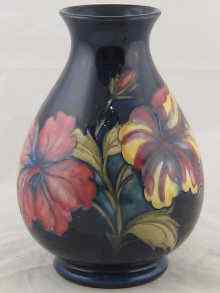 Appraisal: A Moorcroft vase decorated with Hibiscus on a dark blue