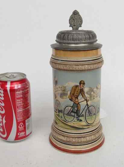 Appraisal: German pewter lid stein with transfer cyclist Pewter lid has