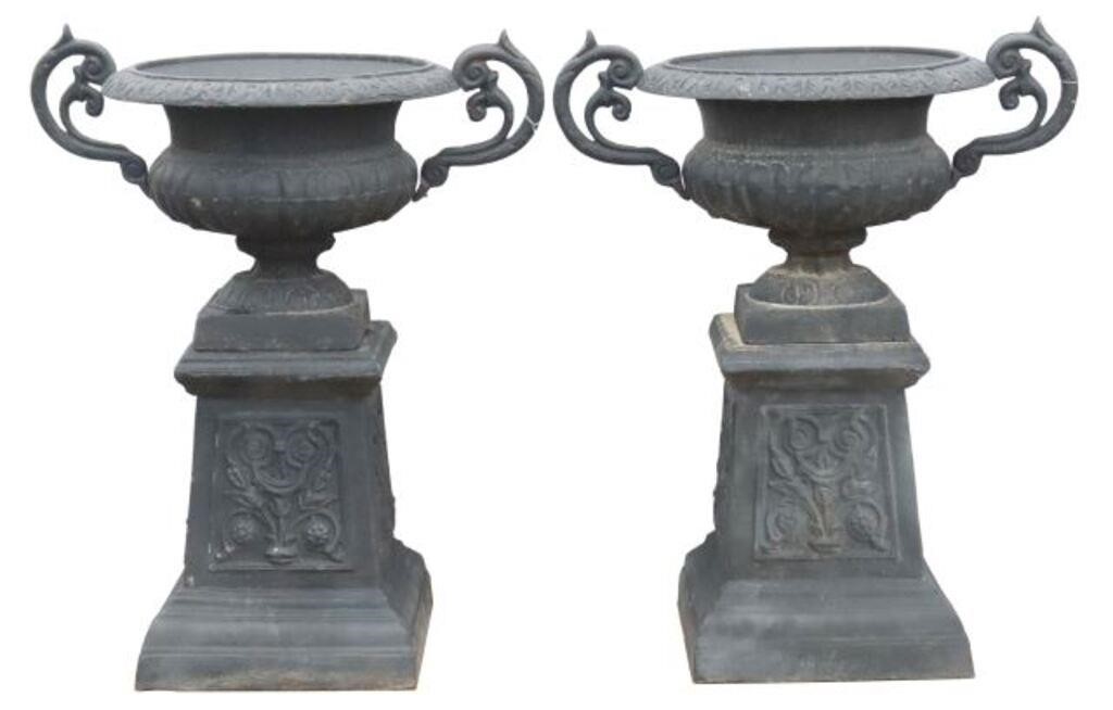 Appraisal: CAST IRON GARDEN URN PLANTERS ON PEDESTALS pair Cast iron