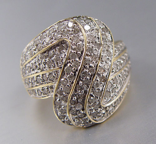 Appraisal: DIAMOND COCKTAIL RING K yellow gold ring contains round full