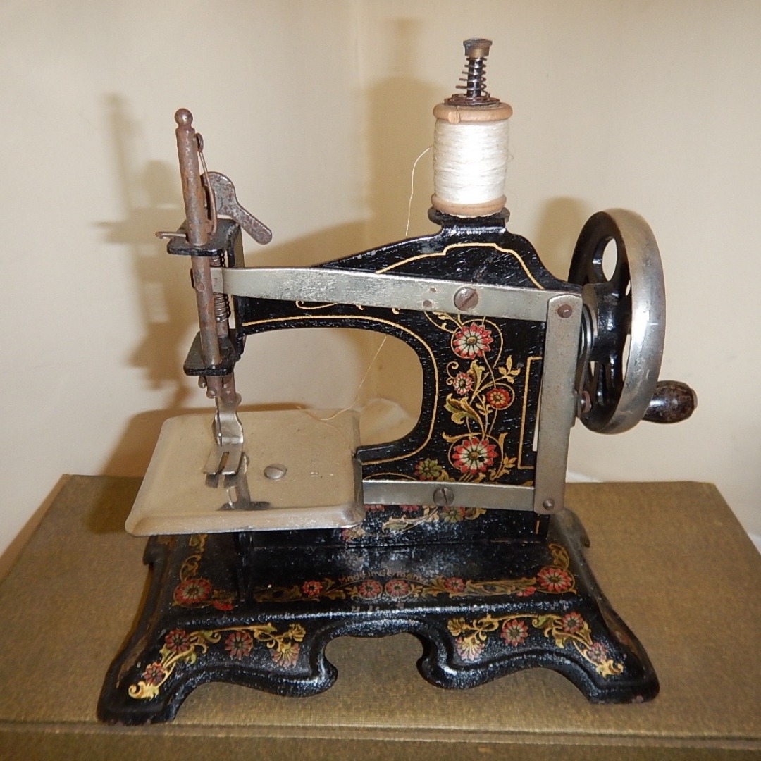 Appraisal: An early thC German tin plate childs sewing machine with