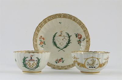 Appraisal: An armorial fluted teabowl and saucer painted with a central