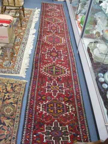 Appraisal: Heriz Persian Handmade Runner geometric medallions red field thick pile