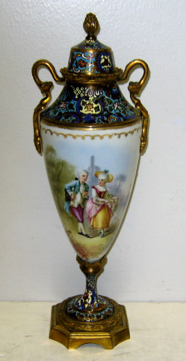 Appraisal: FRENCH PORCELAIN AND CHAMPLEVE ENAMEL URN The ovoid porcelain body