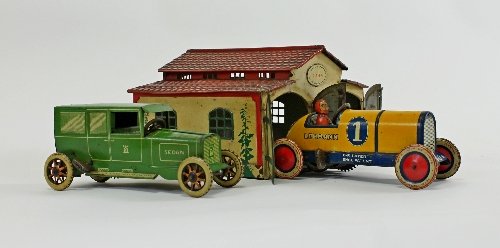 Appraisal: A Lehmann tinplate double garage with red roof and twin