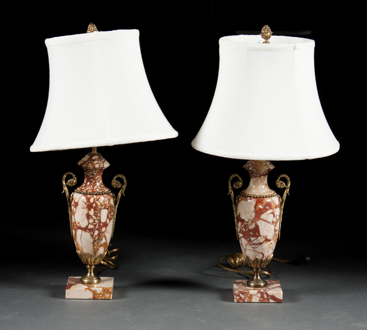 Appraisal: Pair of Rococo style variegated marble urn lamps each with