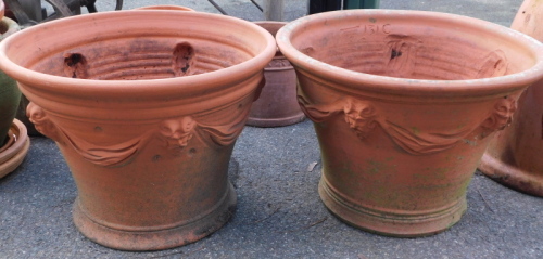 Appraisal: A pair of terracotta garden planters each with lion mask