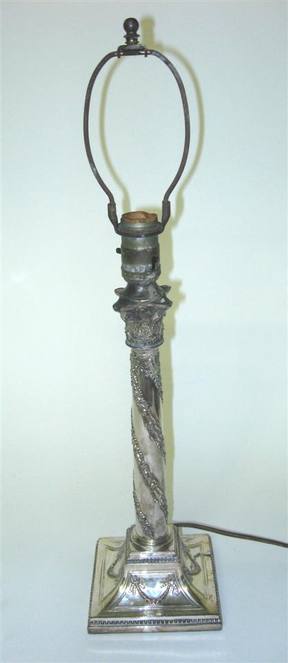 Appraisal: Silver plate corinthium candlestick Cast with ribbon tied floral garlands