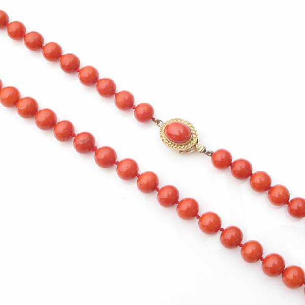 Appraisal: A single strand of coral beaded necklace with k gold