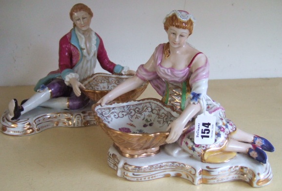 Appraisal: A pair of continental porcelain figural salts modelled as gallant