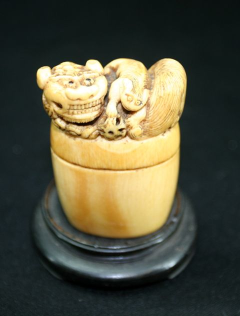 Appraisal: A Japanese carved ivory box and cover the cover carved