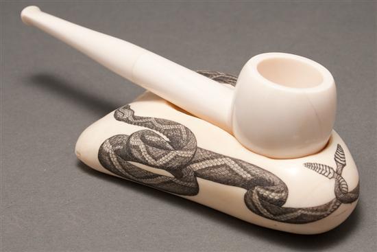 Appraisal: Scrimshaw rattlesnake decorated whale's tooth pipe rest and a carved