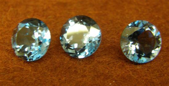 Appraisal: Three loose round cut blue topaz approximate total weight cts