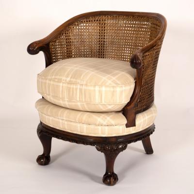 Appraisal: A tub armchair with a cane back above a cream