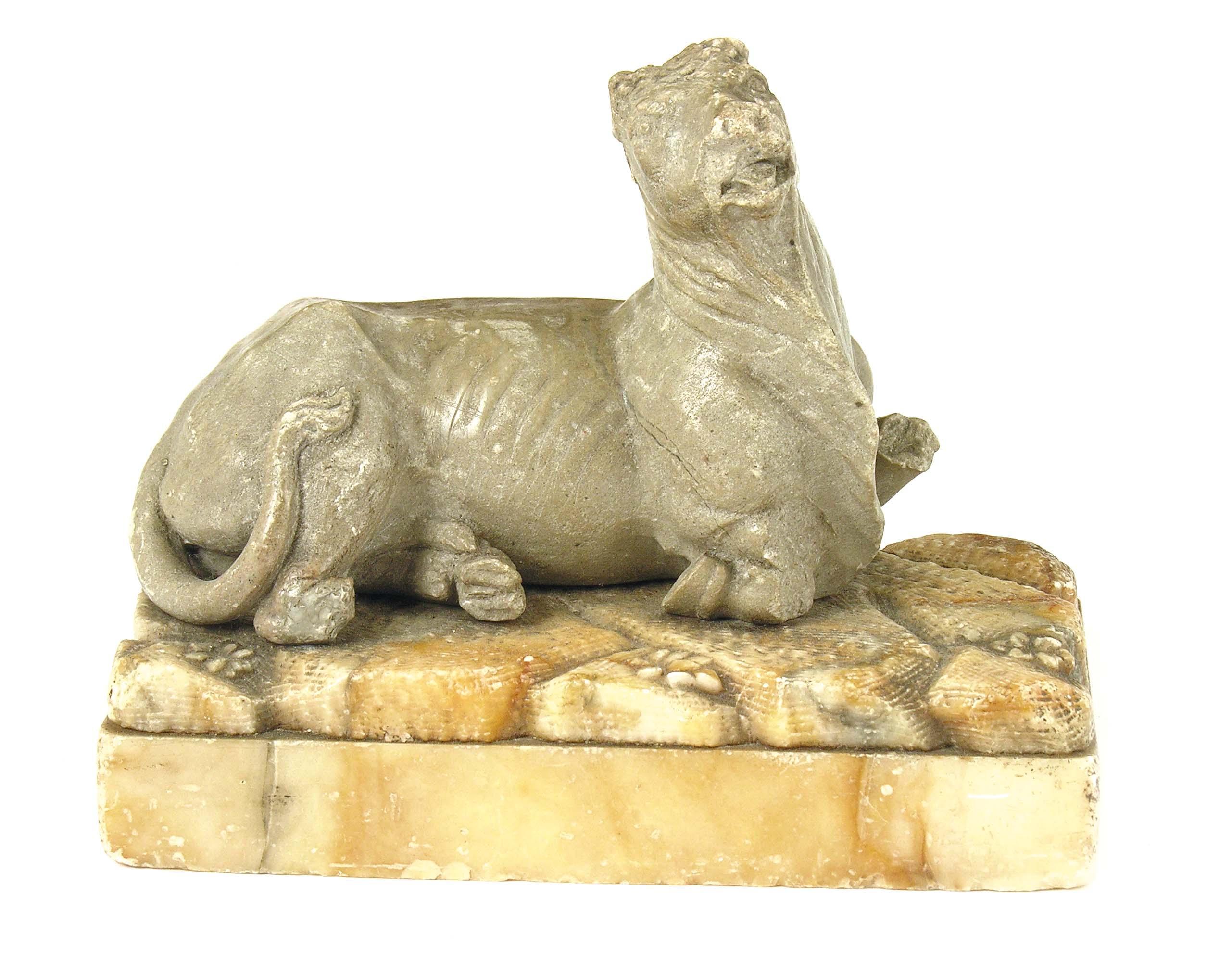 Appraisal: A carved marble model of a recumbent bull