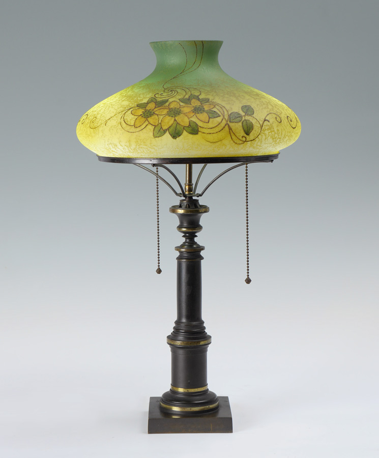 Appraisal: HANDEL SIGNED REVERSE PAINTED SHADE LAMP Weighted cast mixed metal