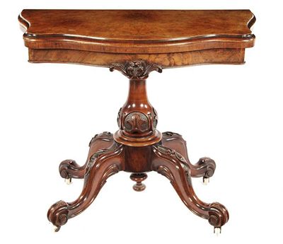 Appraisal: A Victorian walnut serpentine front card table the folding and