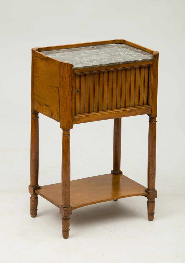 Appraisal: LOUIS XVI PROVINCIAL FRUITWOOD BEDSIDE TABLE With an inset grey