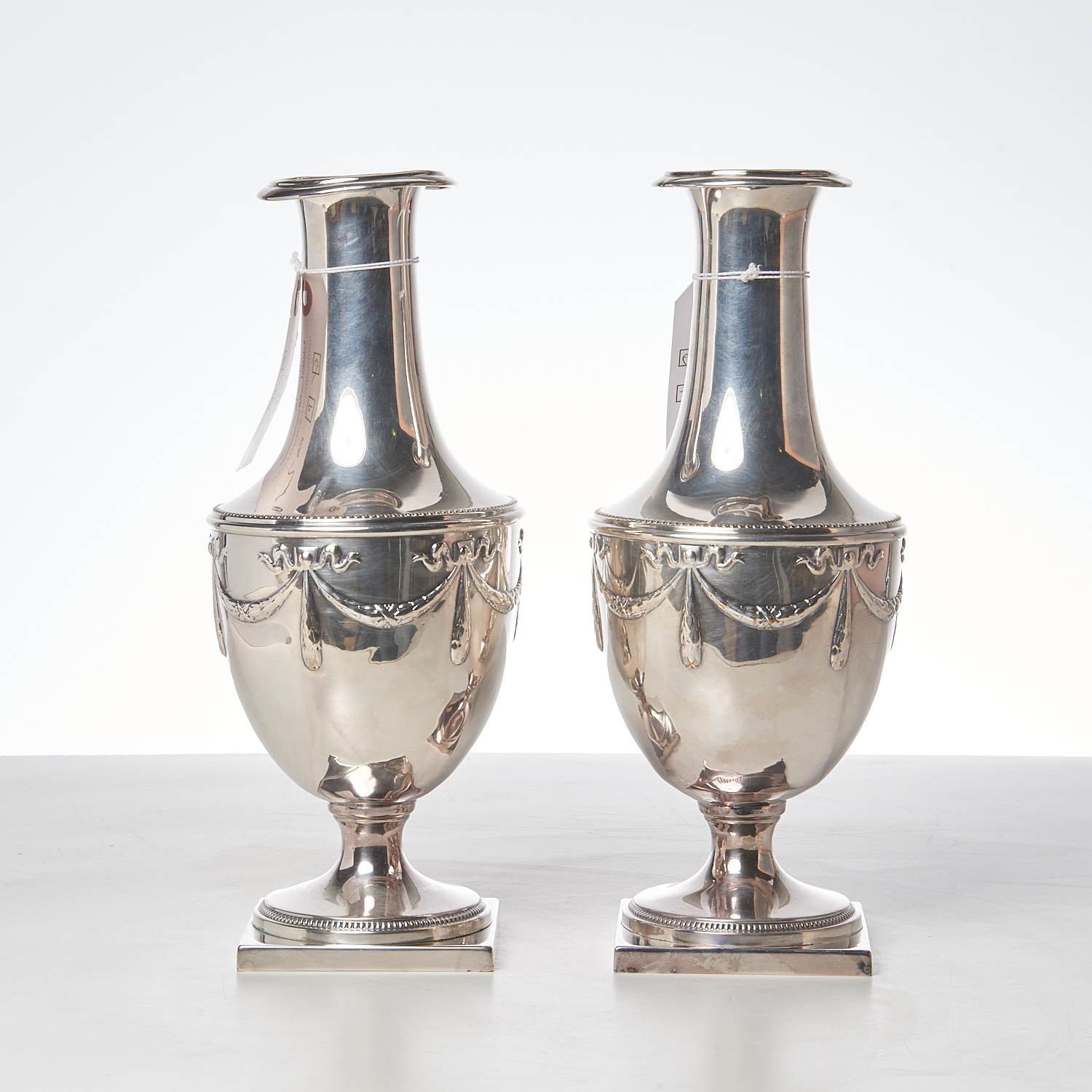 Appraisal: PAIR NEO-CLASSICAL SILVER PLATED URNS th th c repousse decoration