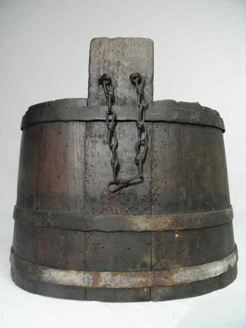 Appraisal: A primitive wood liquid cask with iron banding Handmade may