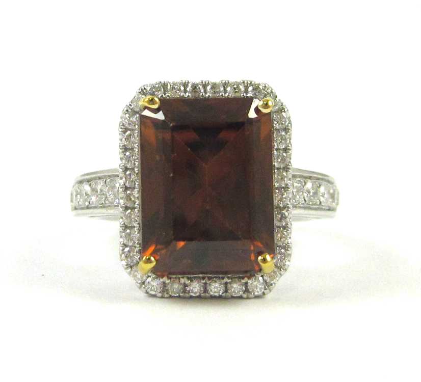 Appraisal: RED ORANGE ZIRCON AND DIAMOND RING The k white gold