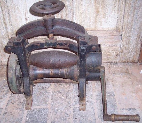 Appraisal: A cast iron hand operated leather press with shaped rollers