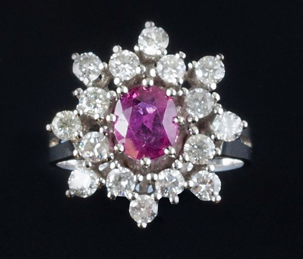 Appraisal: A ruby and diamond cluster ring the oval mixed-cut ruby