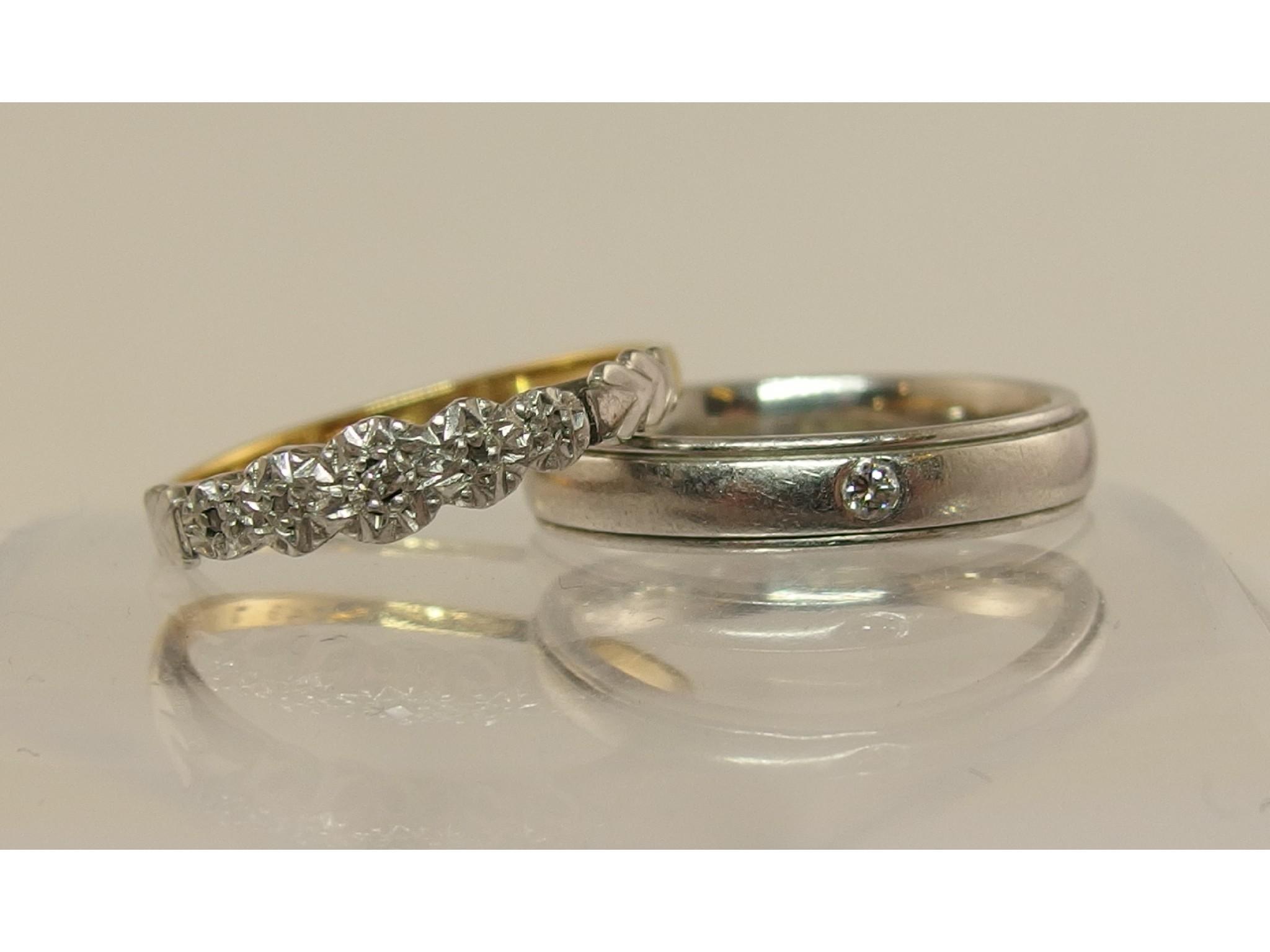 Appraisal: A platinum diamond set wedding band and an ct and