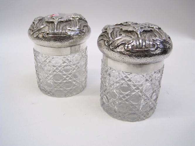 Appraisal: PAIR JAPANESE SILVER LIDDED GLASS DRESSER JARS chased iris pattern