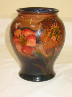 Appraisal: A MOORCROFT FLAMBE POTTERY VASE of baluster form tube lined