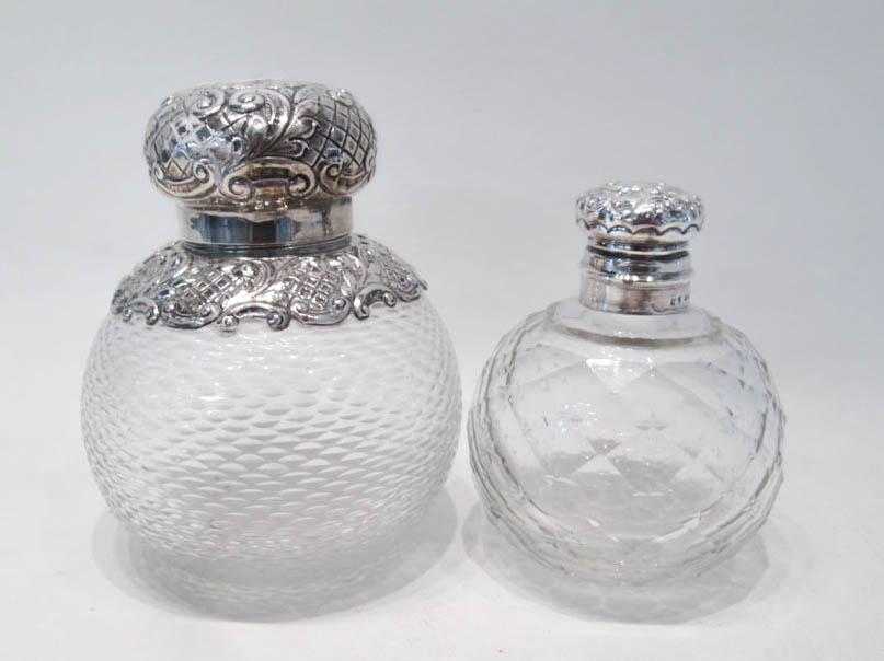 Appraisal: TWO CRYSTAL SCENT BOTTLES WITH SILVER LIDS the smaller having