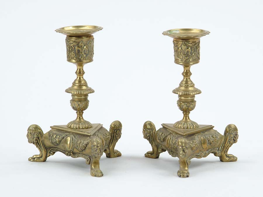 Appraisal: PAIR OF ANTIQUE FANCY BRASS CANDLESTICKS Triangular bases with figures