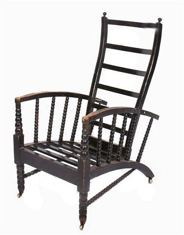 Appraisal: An ebonised Arts and Crafts adjustable open armchair with bobbin