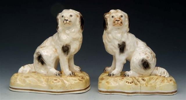 Appraisal: A PAIR OF ROCKINGHAM STYLE PORCELAIN SEATED SPANIELS each on